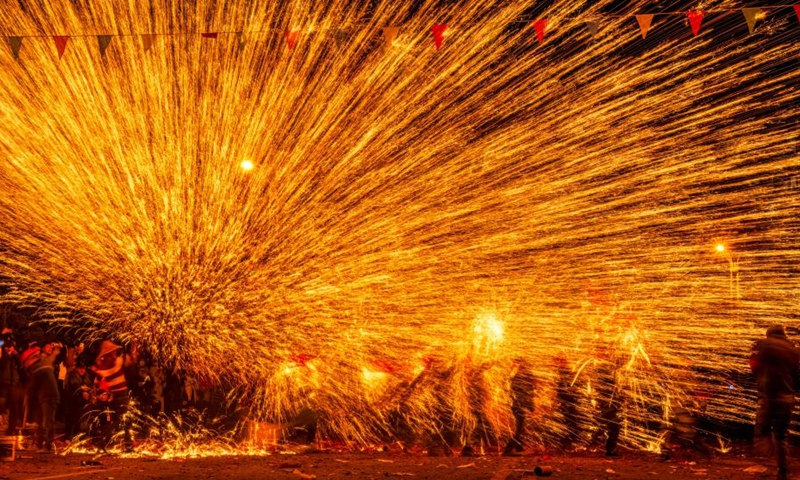 Folk artists play iron flowers, a performance of splashing molten iron to create fireworks, in celebration of the upcoming Latern Festival at Goujiang Township of Bozhou District, Zunyi City of southwest China's Guizhou Province, Jan. 30, 2023. The Lantern Festival, the 15th day of the first month of the Chinese lunar calendar, falls on Feb. 5 this year. The festival features family reunions, feasts, light shows and various cultural activities.(Photo: Xinhua)