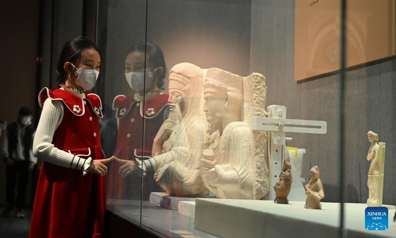 A girl visits an exhibition of antiquities from ancient Syria at Hebei Museum in Shijiazhuang, north China's Hebei Province, Jan. 31, 2023. The exhibition displaying antiquities of nine museums in Syria will last till April 9. (Photo: Xinhua)