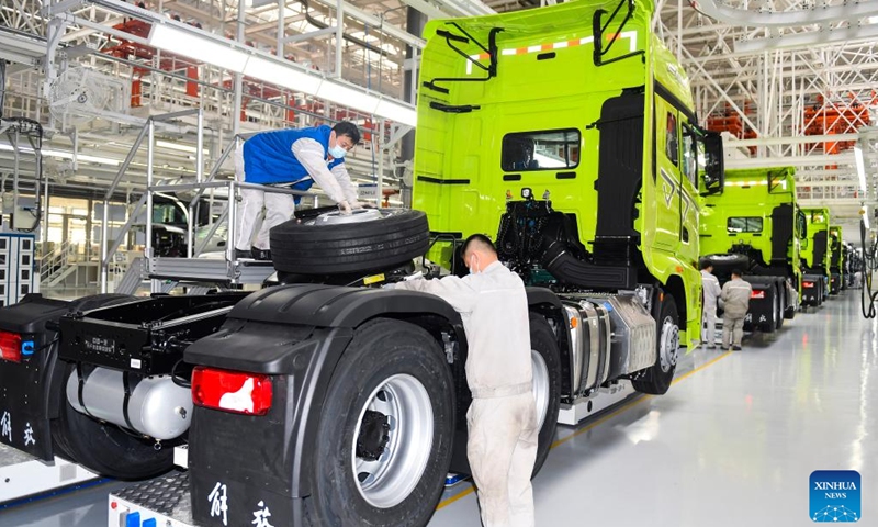 Workers work at the intelligent plant for manufacturing the FAW Jiefang J7 trucks in Changchun, northeast China's Jilin Province, Jan. 31, 2023. Chinese truck maker FAW Jiefang has kick-started full production after the Spring Festival holiday.(Photo: Xinhua)