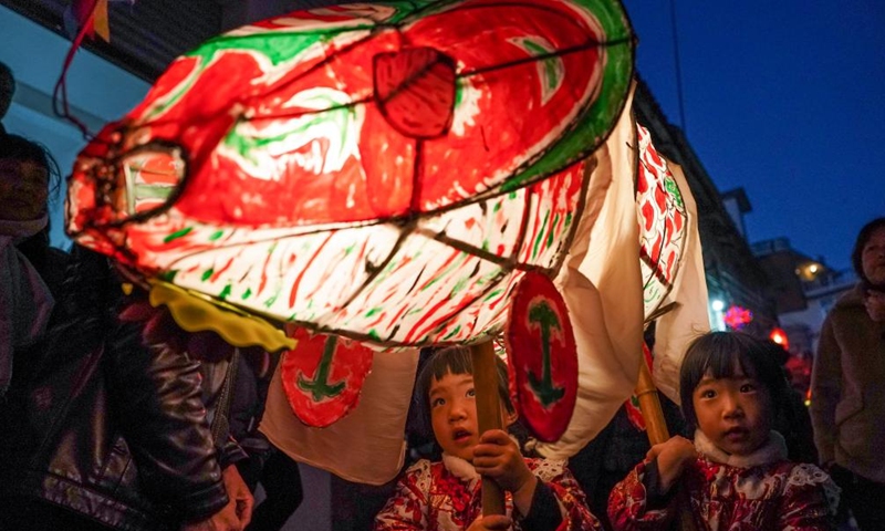 Children holding fish-shaped lanterns parade during the new year celebrations in Shexian County of Huangshan City, east China's Anhui Province, Jan. 31, 2023.(Photo: Xinhua)