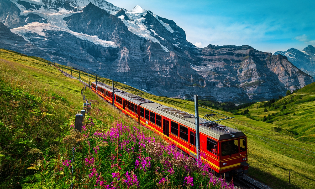 A passenger train passes through the Jungfrau Mountains. Photo: IC