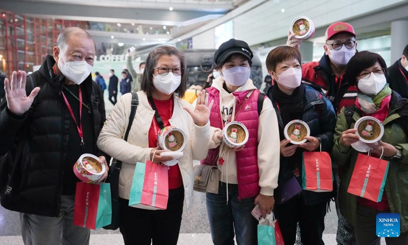 Tourists of the first tour group from Hong Kong pose for a group photo at Beijing Capital International Airport in Beijing, capital of China, Feb. 6, 2023. The Chinese mainland fully resumed normal travel with the Hong Kong and Macao special administrative regions (SARs) starting Monday, in what is expected to be a strong boost for the two regions' economic development.(Photo: Xinhua)