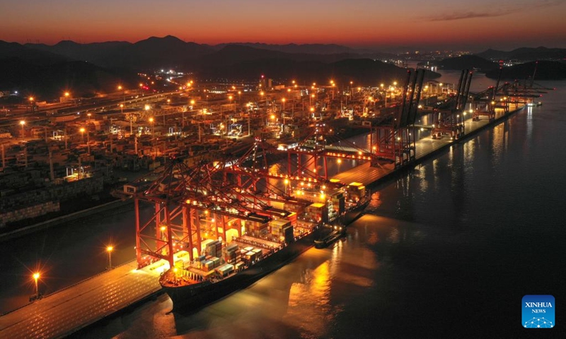 This aerial photo taken on Jan. 31, 2023 shows a cargo ship docking at a container terminal of Ningbo Zhoushan Port in east China's Zhejiang Province. China's busiest port, the Port of Ningbo Zhoushan in the eastern province of Zhejiang, saw its cargo throughput exceed 1.25 billion tonnes in 2022, ranking first globally for a 14th consecutive year, according to the port.(Photo: Xinhua)