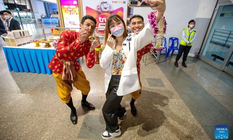 A Chinese tourist takes a selfie with Thai staff members at Don Mueang International Airport in Bangkok, Thailand, Feb. 6, 2023.(Photo: Xinhua)