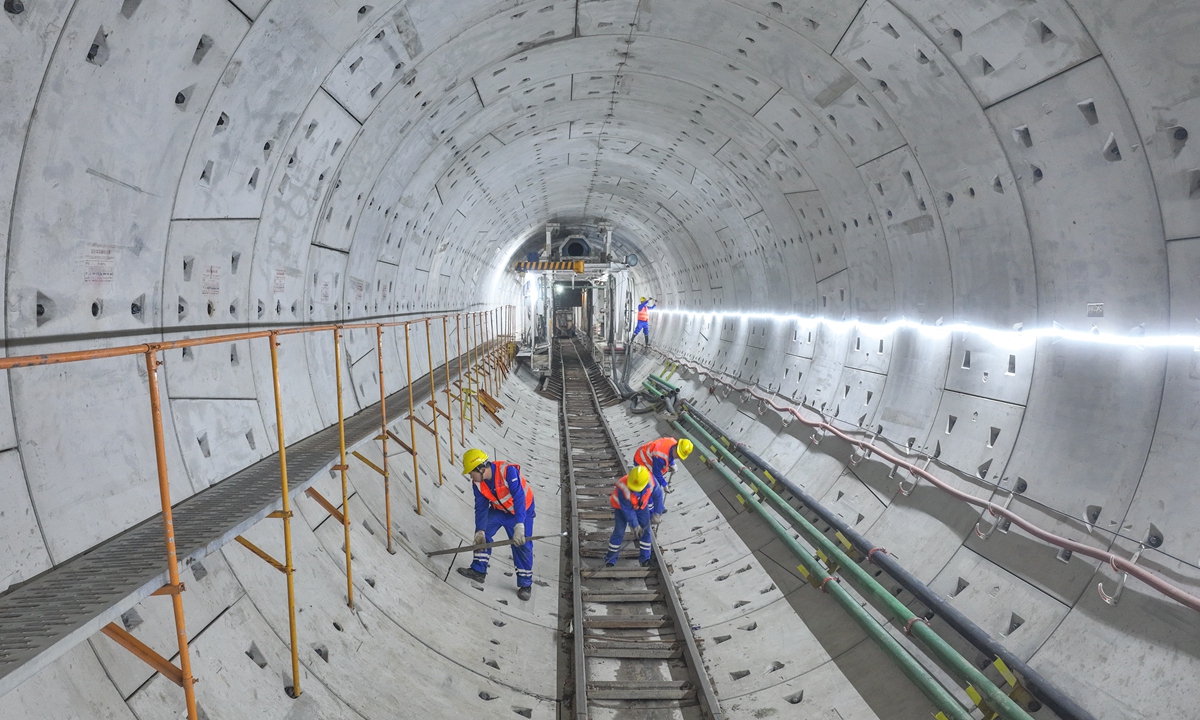 Workers install gear inside a tunnel in Huzhou, East China's Zhejiang Province on February 2, 2023 for the 25.6-kilometer suburban railway in Hangzhou. Some analysts say infrastructure investment in the first quarter could see double-digit growth as localities ramp up projects across China. Photo: cnsphoto