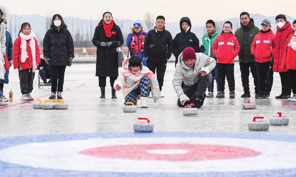 People compete in a curling competition at a park in Zhuolu County, Zhangjiakou, North China's Hebei Province, on February 3, 2023. From February to March, Beijing and Hebei will jointly hold a series of activities to commemorate the first anniversary of the Beijing 2022 Winter Olympic Games, promote Olympic culture and continue to boost people's enthusiasm for ice and snow sports. Photo: cnsphoto