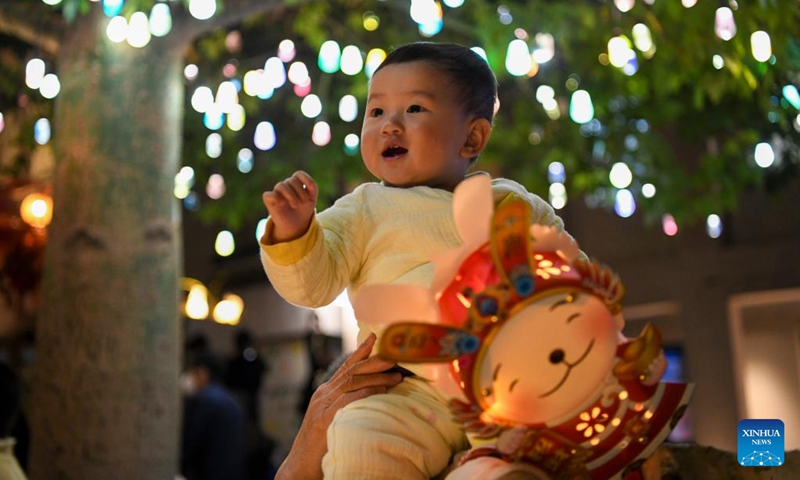 A kid is pictured at a Lantern Festival fair held in Nantou ancient town in Shenzhen, south China's Guangdong Province, on Feb. 4, 2023. A fair was held in Nantou ancient town to celebrate the upcoming Lantern Festival, which falls on Feb. 5 this year. (Xinhua/Liang Xu)