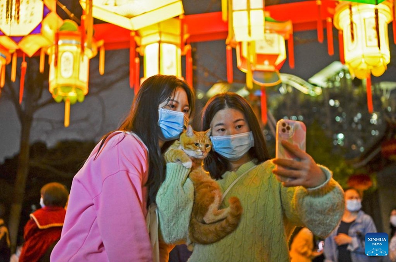 Tourists pose for photos with lanterns during a Lantern Festival fair held in Nantou ancient town in Shenzhen, south China's Guangdong Province, on Feb. 4, 2023. A fair was held in Nantou ancient town to celebrate the upcoming Lantern Festival, which falls on Feb. 5 this year. (Xinhua/Liang Xu)