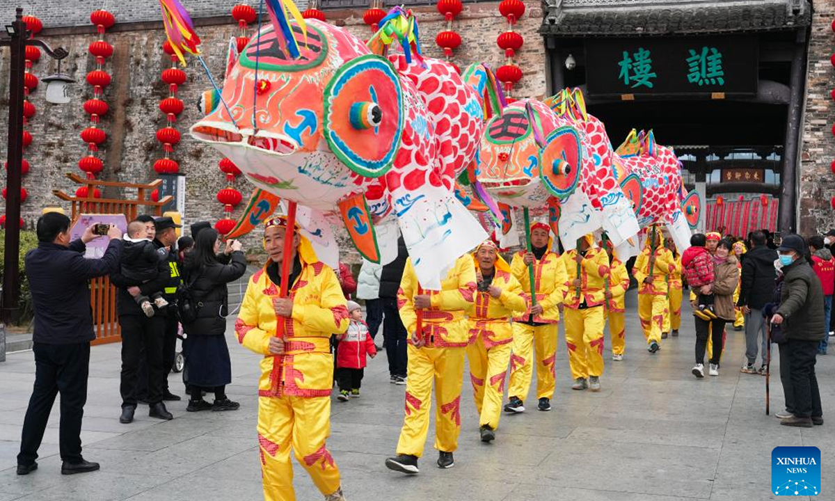 Folk artists holding fish-shaped lanterns perform at Shexian County in Huangshan, east China's Anhui Province, Feb 4, 2023. The Lantern Festival, the 15th day of the first month of the Chinese lunar calendar, falls on Feb 5 this year. Various folk cultural activities were held across the country to welcome the upcoming festival. Photo: Xinhua