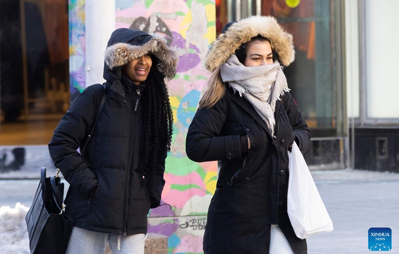 People brave the cold as they walk on a street in Toronto, Canada, on Feb. 3, 2023. Environment Canada has issued an extreme cold warning for Toronto on Friday. (Photo by Zou Zheng/Xinhua)