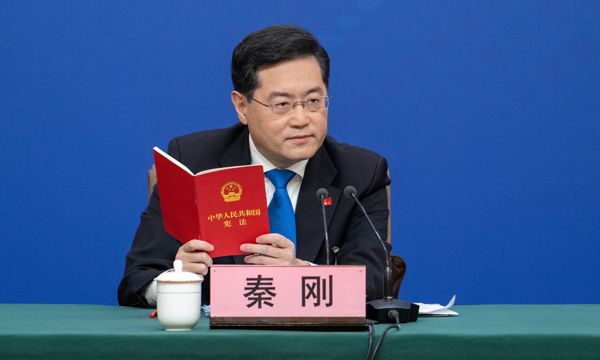 Chinese Foreign Minister Qin Gang, with a copy of the Constitution of the People's Republic of China in his hands, responds to a question concerning the Taiwan question at a press conference on sidelines of the Two Sessions on March 7, 2023. Photo: IC