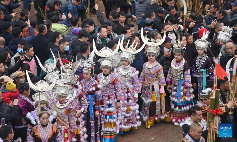 People of the Miao ethnic group dance with Lusheng, a traditional reed-pipe wind instrument, during the pohui festival in Xiangfen Town of Rongshui Miao Autonomous County, south China's Guangxi Zhuang Autonomous Region, Feb. 6, 2023. Since the Spring Festival, villages in Rongshui Miao Autonomous County have held various activities to celebrate the pohui festival, a traditional festival observed by the Miao ethnic minority, and to boost local tourism.(Photo: Xinhua)