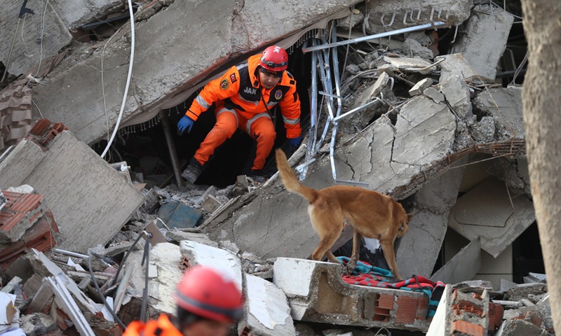 A rescuer searches for survivors among the rubble of a building destroyed in a powerful earthquake in Kahramanmaras, Türkiye, on Feb. 7, 2023.(Photo: Xinhua)
