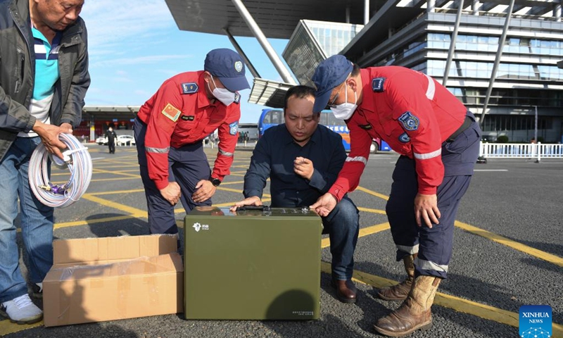 Rescuers of Shenzhen Rescue Volunteers Federation (SRVF) receive a portable water purifier donated by a company at Shenzhenwan Port in Shenzhen, south China's Guangdong Province, Feb. 9, 2023. Another 17 SRVF members carrying relief supplies headed for Türkiye on Thursday to offer assistance in quake-relief efforts.(Photo: Xinhua)