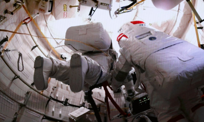 This screen image captured at Beijing Aerospace Control Center on Feb. 9, 2023 shows Shenzhou-15 taikonauts Fei Junlong (R) and Zhang Lu (L) preparing to exit the space station lab module Wentian.(Photo: Xinhua)
