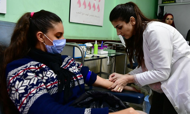 A woman donates blood for quake victims at a blood donation center in Damascus, capital of Syria, on Feb. 8, 2023.(Photo: Xinhua)