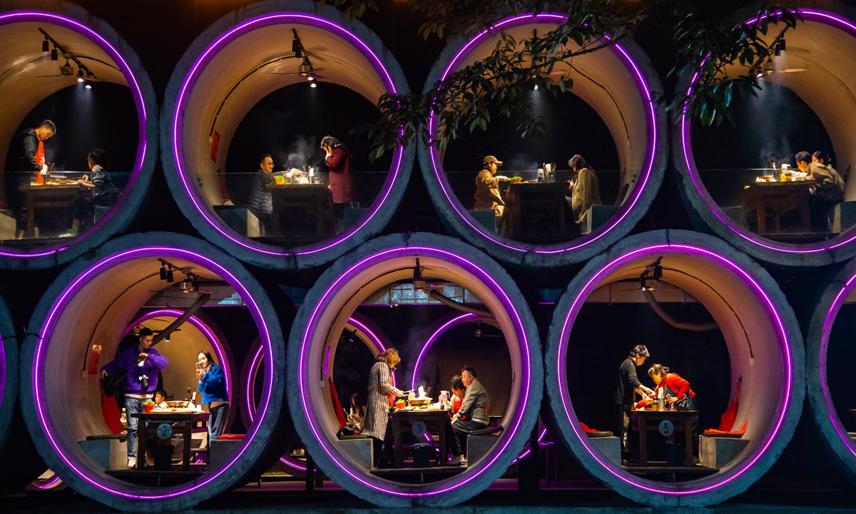 Customers eat inside a giant concrete pipe built on two layers on top of a barbecue restaurant in Southwest China's Chongqing Municipality on February 7, 2023. Photo: IC