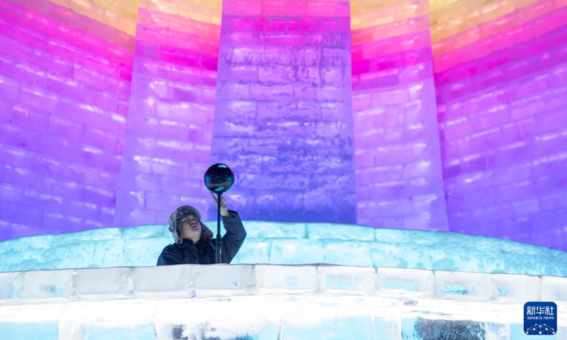 A staff member of an ice and snow metaverse experience center captures the 360 degree panoramic view in the Harbin Ice and Snow World in Harbin, northeast China's Heilongjiang Province, Feb. 12, 2023. Recently, the ice and snow metaverse experience center at the Harbin Ice and Snow World in Harbin has drawn much attention. It enables visitors to enjoy the ice and snow scenery and activities regardless of the seasons.(Photo: Xinhua)