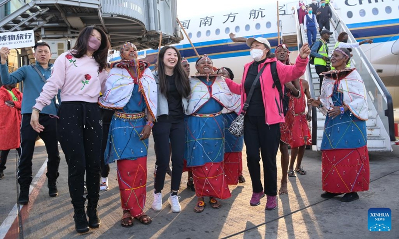 Chinese tourists interact with Maasai performers at Jomo Kenyatta International Airport in Nairobi, Kenya, Feb. 11, 2023. A flight carrying 40 Chinese group tourists arrived at Jomo Kenyatta International Airport in Nairobi on Saturday. This is the first outbound tour group from China to Kenya since China resumed outbound group travel to 20 countries.(Photo: Xinhua)