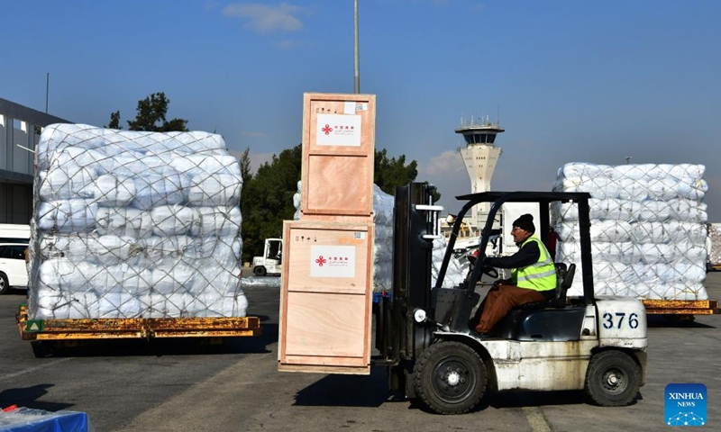 A worker drives a forklift to transfer humanitarian aid from China at Damascus international airport in Damascus, capital of Syria, on Feb. 15, 2023.(Photo: Xinhua)