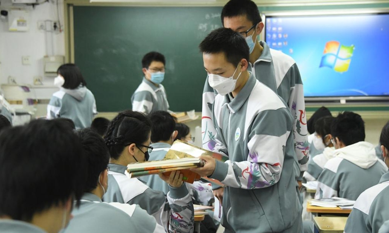 Students deliver teaching materials on their first day of the new semester at a senior high school in Beijing, capital of China, Feb. 13, 2023. Primary and middle school students in Beijing returned to school for the spring semester on Monday.(Photo: Xinhua)