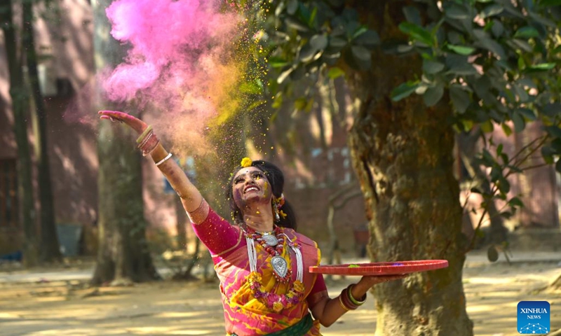 A young woman scatters colored powder to celebrate the Pohela Falgun in Dhaka, Bangladesh, Feb. 14, 2023. Local dwellers thronged the Bangladeshi capital to celebrate Pohela Falgun, the first day of spring and of the Bengali month Falgun, along with Valentine's Day.(Photo: Xinhua)