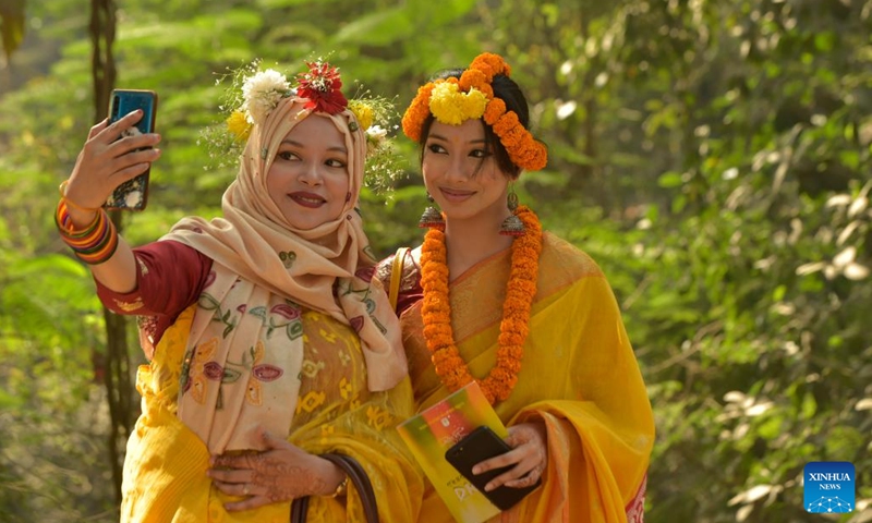Women take selfies during the celebration of Pohela Falgun in Dhaka, Bangladesh, Feb. 14, 2023. Local dwellers thronged the Bangladeshi capital to celebrate Pohela Falgun, the first day of spring and of the Bengali month Falgun, along with Valentine's Day.(Photo: Xinhua)