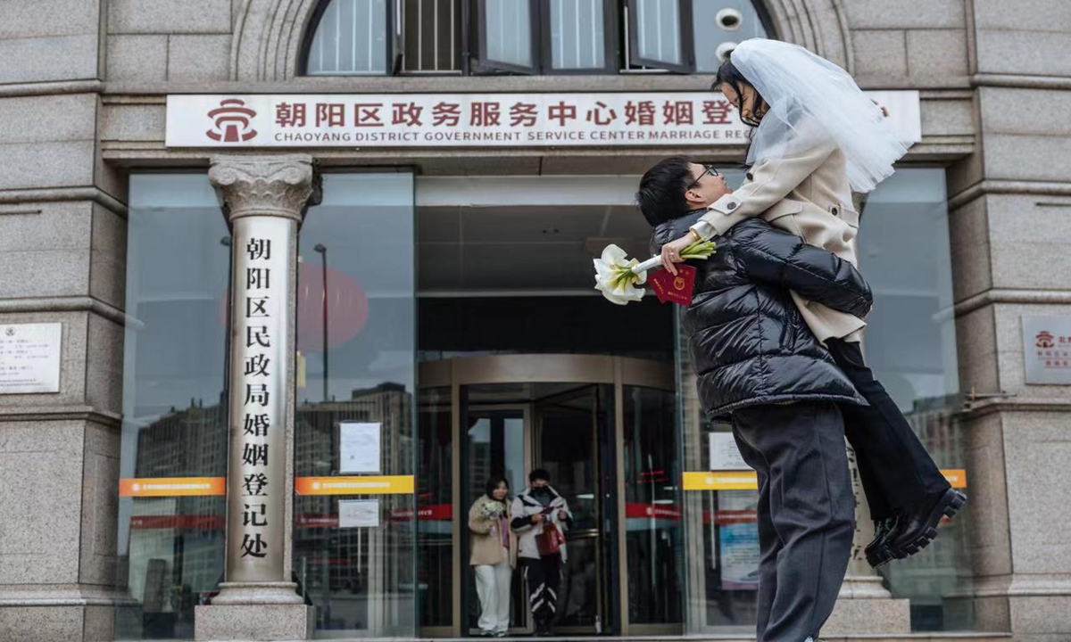 A newly married couple outside the marriage registration office in Beijing's Chaoyang district on February 14, 2023. Photo: Li Hao/GT