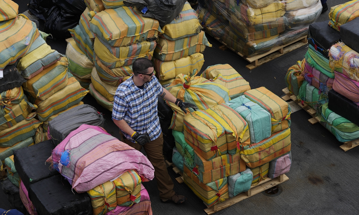 A man walks past a large consignment of drugs seized by police in Fort Lauderdale, Florida, on February 17, 2022. Photo: Xinhua