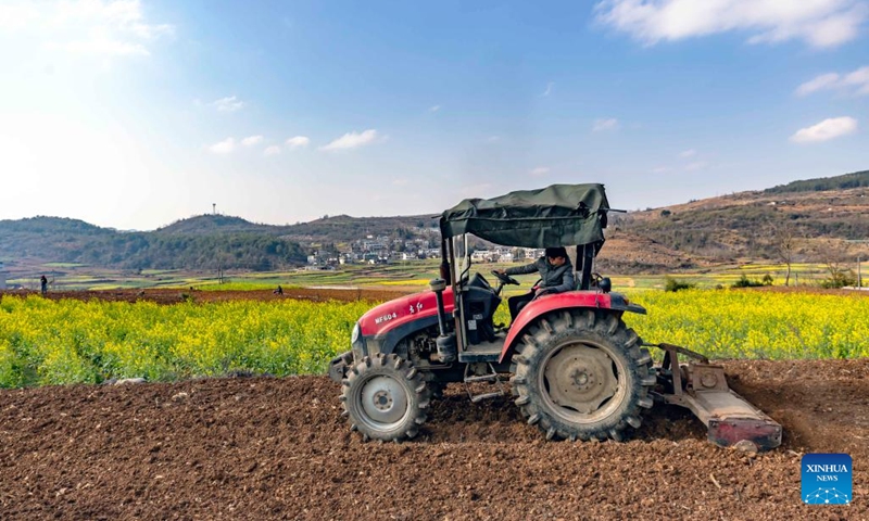 A farmer drives a tractor in the fields at Xintuan Village of Qianxi City, southwest China's Guizhou Province, Feb. 14, 2023.(Photo: Xinhua)