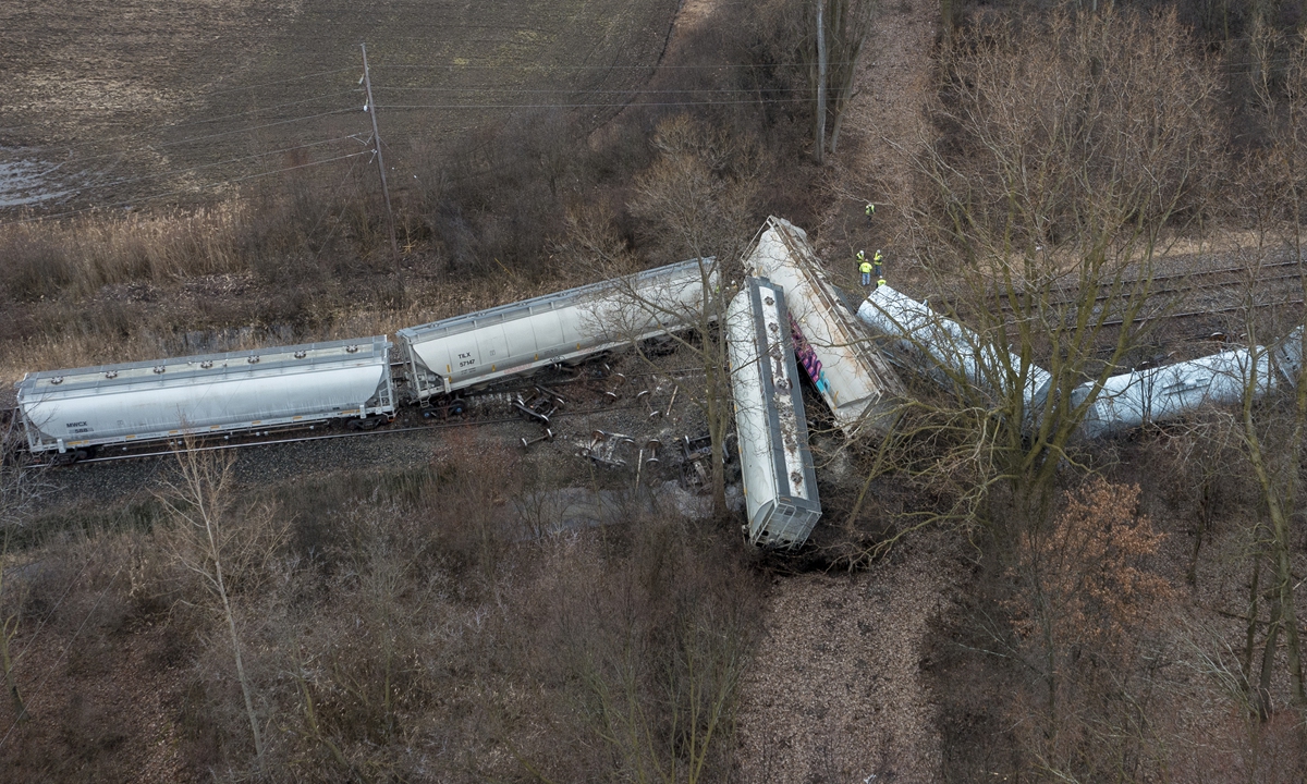 An emergency crew works at the site of a Norfolk Southern train derailment in Van Buren Township, near Detroit, on February 16, 2023. An investigation is ongoing, while the local authority said there are no reports of injuries and no hazardous materials were onboard the overturned portion of the train. Photo: VCG