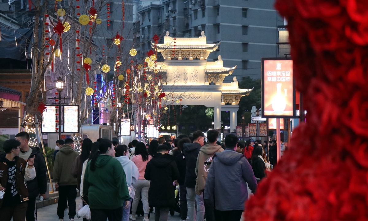 Residents and tourists enjoy nighttime activities such as shopping and cultural performances at Wanshou Palace commercial street in Nanchang, East China's Jiangxi Province, on February 18, 2023. As the weather warms up, the streets and alleys in Nanchang have become more lively, and the nighttime economy is helping to drive urban consumption. Photo: VCG