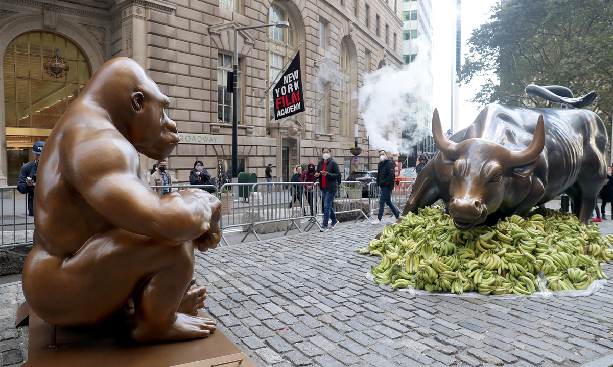 As part of the protest against rising economic polarization, a gorilla statue is placed faces off a 