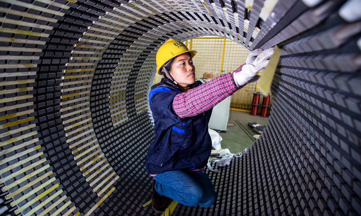 A worker makes a high-voltage electric motor on February 21, 2023 in Nantong, East China's Jiangsu Province to finish orders. China's official purchasing managers' index showed signs of economic recovery in January, with a sub-index for new export orders rising to 46.1 from 44.2 in December. Photo: cnsphoto