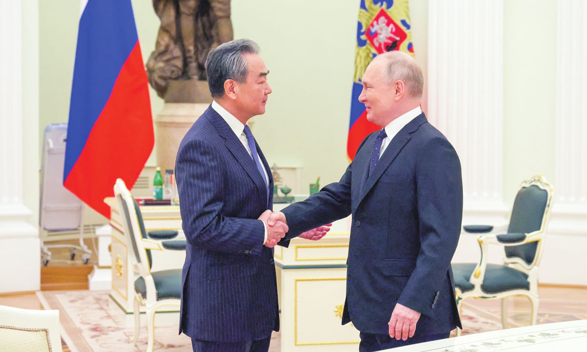 Russian President Vladimir Putin (right) meets with China’s Director of the Office of the Central Foreign Affairs Commission Wang Yi at the Kremlin in Moscow on February 22, 2023. Photo: AFP