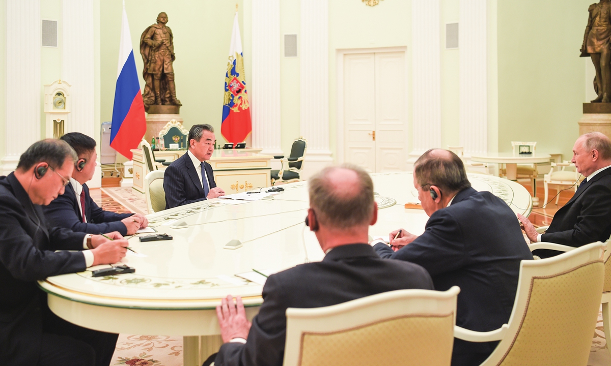 Wang Yi (third from left) attends a meeting with Russian President Vladimir Putin (first from right) at the Kremlin in Moscow on February 22, 2023. Photo: Xinhua