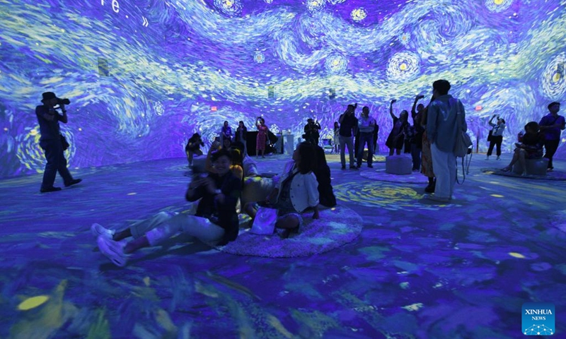 People attend a preview event of Van Gogh: The Immersive Experience at Singapore's Resort World Sentosa, Feb 28, 2023. The exhibition will be open to the public from March 1 to Oct. 1.(Photo: Xinhua)