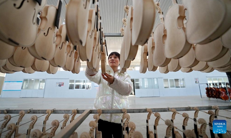A worker arranges musical instruments at a manufacturer in Wuqiang County, north China's Hebei Province, Feb. 23, 2023.

There are 63 musical instrument manufacturers in Wuqiang County, employing more than 10,000 people. More than 400 types of musical instruments are produced in the county and are sold to more than 80 countries and regions. (Xinhua/Mu Yu)