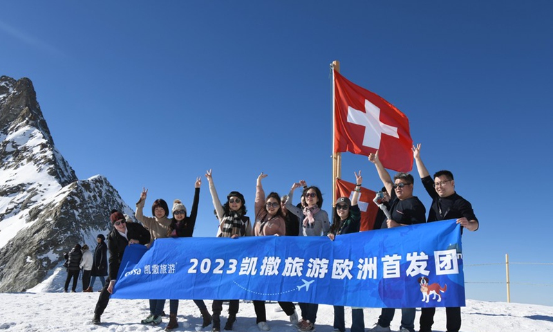 Chinese tourists pose for a group photo at Observation Terrace Sphinx on Jungfrau Mountain at the altitude of 3,571 meters above sea level in Switzerland, Feb. 14, 2023. 