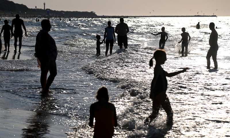 People play on the beach near Baltic city Ustka, Poland, on Aug. 13, 2022. (Photo by Alexey Vitvitsky/Xinhua).