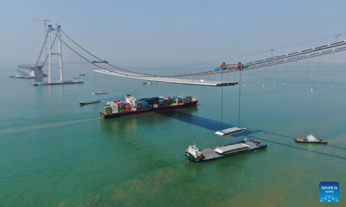 This aerial photo taken on Feb 22, 2023 shows a cargo ship sailing beneath the Lingdingyang bridge under construction in south China's Guangdong Province. The bridge is a key part of the Shenzhen-Zhongshan highway. Photo:Xinhua