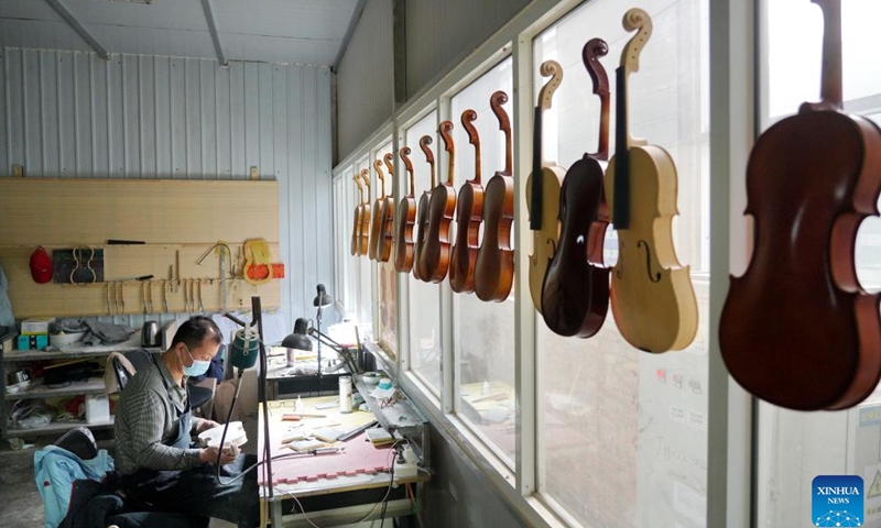 A worker makes violins at a musical instrument manufacturer in Wuqiang County, north China's Hebei Province, on Feb. 23, 2023.

There are 63 musical instrument manufacturers in Wuqiang County, employing more than 10,000 people. More than 400 types of musical instruments are produced in the county and are sold to more than 80 countries and regions. (Xinhua/Mu Yu)