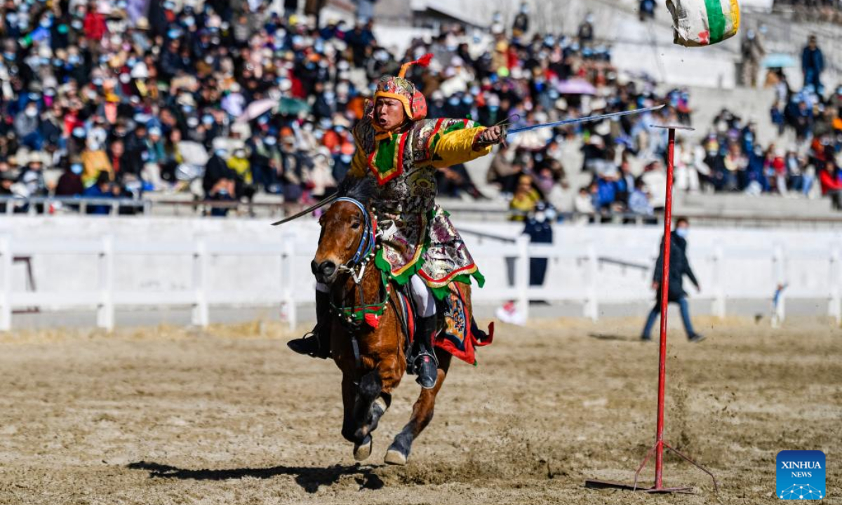 A rider on horseback performs during an equestrian show in Lhasa, southwest China's Tibet Autonomous Region, Feb 23, 2023. An annual equestrian show was held here on Thursday to celebrate the Tibetan New Year. Photo:Xinhua