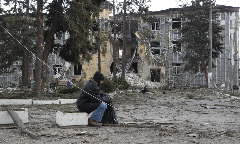 A local resident sits near a damaged building in Volnovakha of Donetsk, March 15, 2022.(Photo: Xinhua)