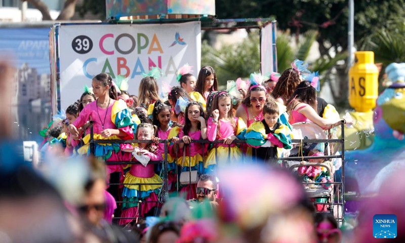 People attend the traditional Limassol Carnival parade in Limassol, in the eastern Mediterranean island of Cyprus, Feb. 26, 2023. (Photo by George Christophorou/Xinhua)