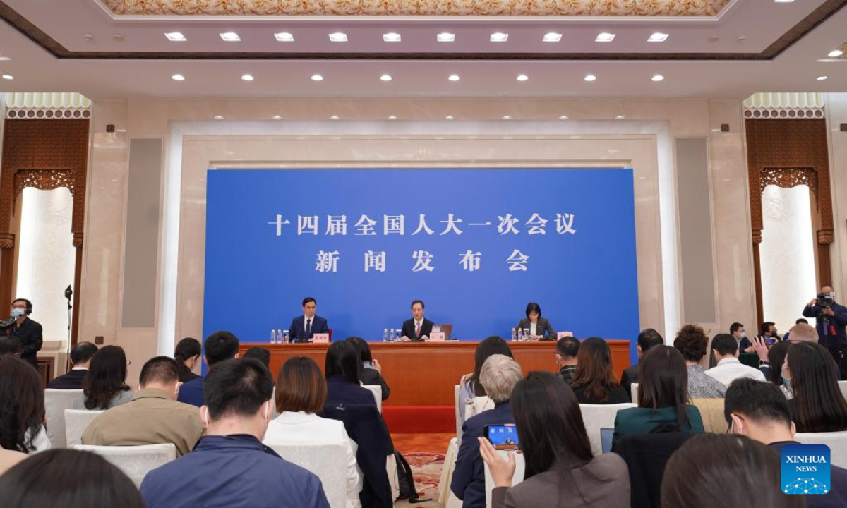 Wang Chao (C, rear), spokesperson for the first session of the 14th National People's Congress (NPC), attends a press conference at the Great Hall of the People in Beijing, capital of China, March 4, 2023. The NPC, China's national legislature, held a press conference Saturday, one day before the opening of its annual session. Photo:Xinhua