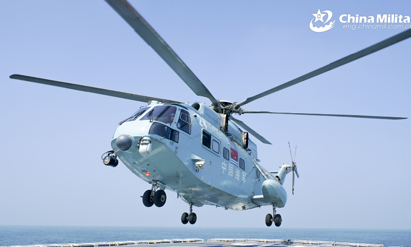 A ship-borne helicopter assigned to the PLA Naval Aviation University lands on the helipad of a vessel assigned to a naval flotilla under the PLA North Theater Command during a combat rescue exercise on February 10, 2023. (eng.chinamil.com.cn/Photo by Hu Jiajie)