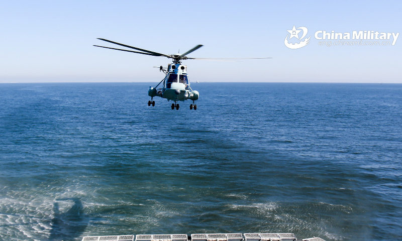 A ship-borne helicopter assigned to the PLA Naval Aviation University conducts joint search and rescue with a vessel assigned to a naval flotilla under the PLA North Theater Command during a combat rescue exercise on February 10, 2023. (eng.chinamil.com.cn/Photo by Hu Jiajie)