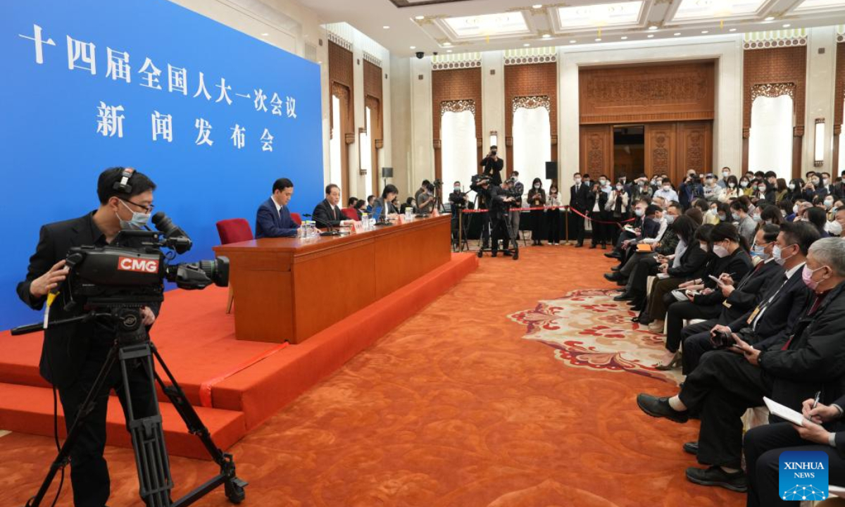 Wang Chao (C, rear), spokesperson for the first session of the 14th National People's Congress (NPC), attends a press conference at the Great Hall of the People in Beijing, capital of China, March 4, 2023. The NPC, China's national legislature, held a press conference Saturday, one day before the opening of its annual session. Photo:Xinhua