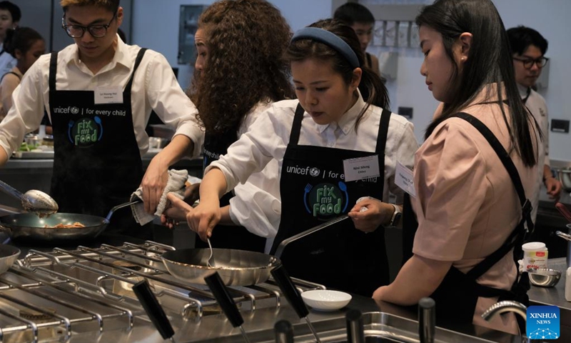 Meng Qianshan (C), a nutrition educator from Chengdu, southwest China's Sichuan Province, takes part in the UNICEF-supported Fix My Food campaign in Bangkok, Thailand, Feb. 27, 2023. Youth and celebrities from eight countries, including China, took part in a UNICEF-supported campaign in Bangkok this week, to promote the need for healthier food environments in the Asia-Pacific.(Photo: Xinhua)